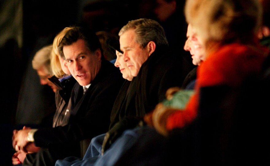 Romney chats with President George W. Bush during the Opening Ceremony at the Salt Lake City Winter Olympic Games in 2002.