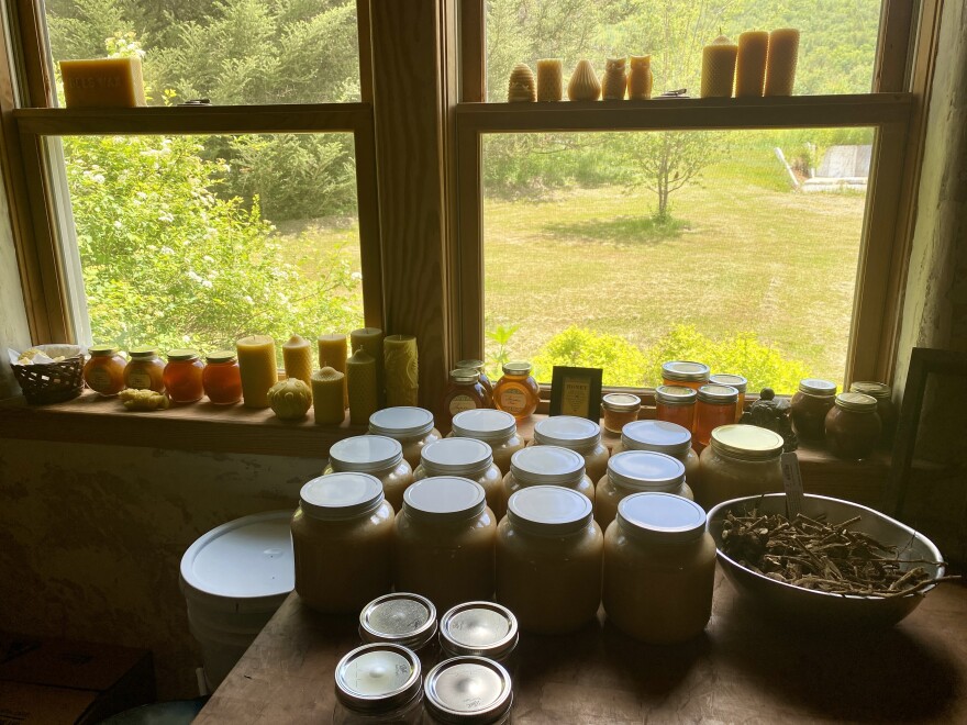 several jars of honey sitting on a table in front of a window