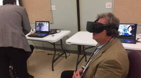 State Sen. Brandt Hershman, R-Buck Creek, tries on an Oculus Rift virtual reality headset at Hope Academy in Indianapolis on Thursday, Aug. 10, 2017.