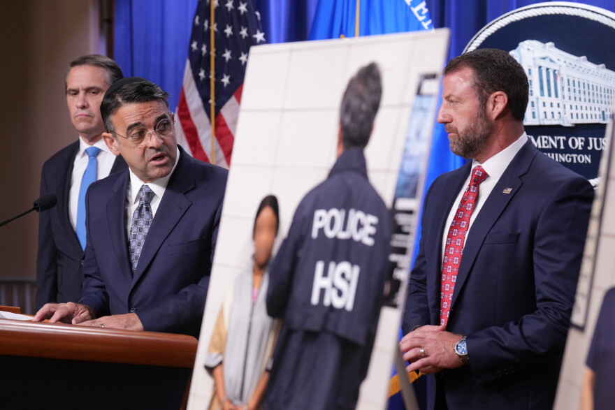 Daniel Rosen, U.S. Attorney for the District of Minnesota, speaks during a news conference at the Department of Justice, Wednesday Sept. 30, 2026, in Washington, as Attorney General Todd Blanche, left, and Secretary of Homeland Security Markwayne Mullin, look on.