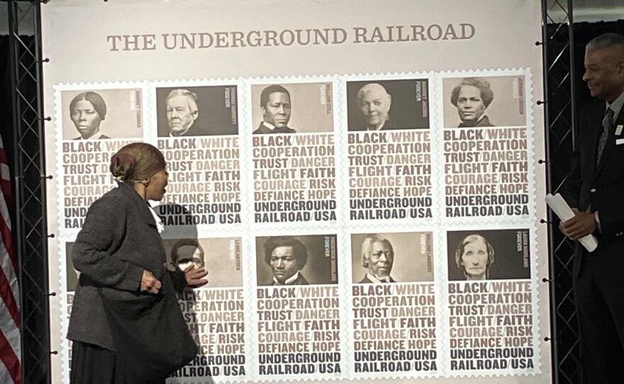 "Harriet Tubman" takes a good look at the new stamps. Photo by John Lee/WYPR. 