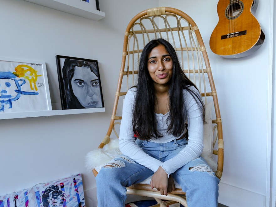Sarav sits in her study in her family's home.
