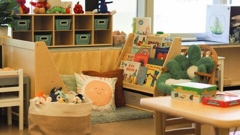 A preschool classroom, with plush toys and boys and small furniture