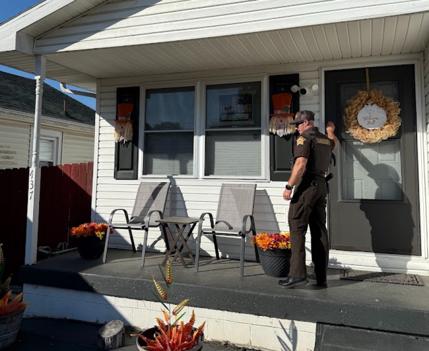 A Vanderburgh County sheriff's deputy knocks on a door to check the status of an offender in advance of Halloween
