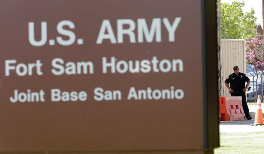 File Photo- A guard stands at a gate to Fort Sam Houston in San Antonio.