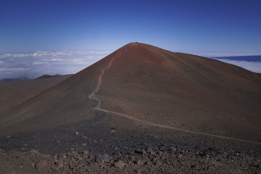 A foot trail leads to an "ahu," or ceremonial platform atop Pu'u Wekiu, an important summit to many Native Hawaiian cultural practitioners, on  Maunakea. (AP Photo/Jessie Wardarski)