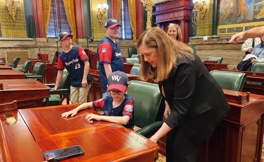 Sen. Lisa Baker shows Wyoming Valley Challenger player Michael Piazza her desk in the Senate.
