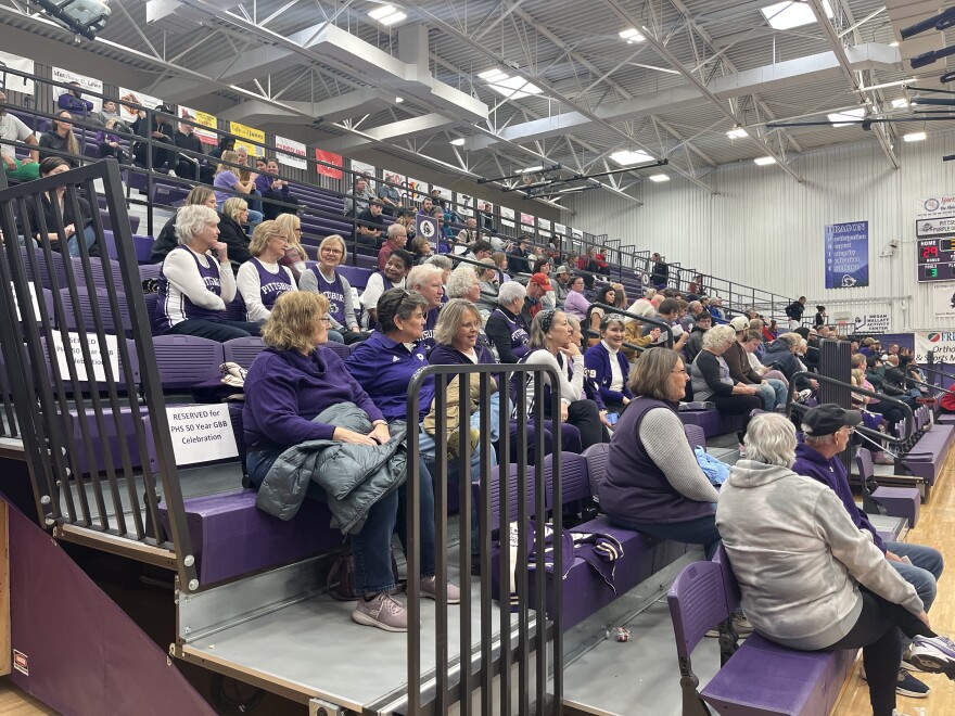 PHS girls basketball alumni watch as the Purple Dragons play Shawnee Mission North.