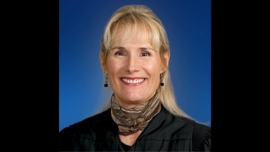 A white woman in judge robes.