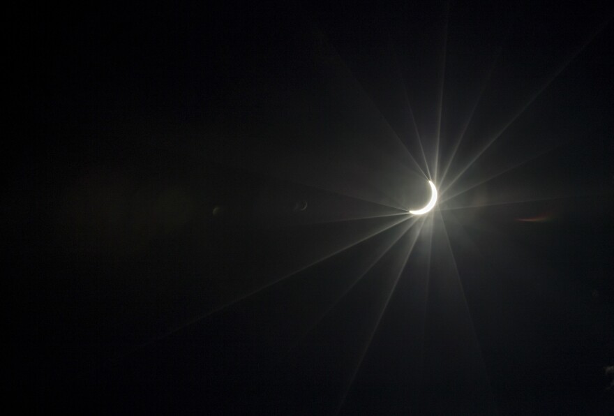 A near total solar eclipse is seen over midtown Atlanta, Monday, Aug. 21, 2017. (AP Photo/David Goldman)