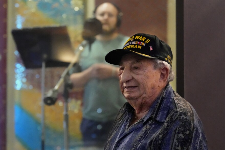 Irving Locker, a 101-year-old veteran of World War II, D-Day and the Battle of the Bulge, listens as Jesse Wayne Taylor, left, records a song based on Locker's military experience on Sept. 9 in Nashville, Tenn.