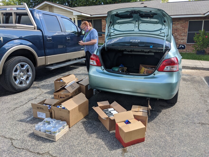 Shannon unloads food she picked up at the San Antonio Food Bank for herself and her neighbors.