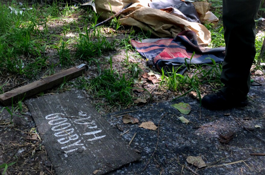 Jackson County deputies walk through an empty camp.