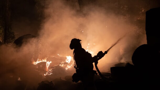 Firefighters protect homes in Christmas Valley from the Caldor Fire Monday, Aug. 30, 2021.