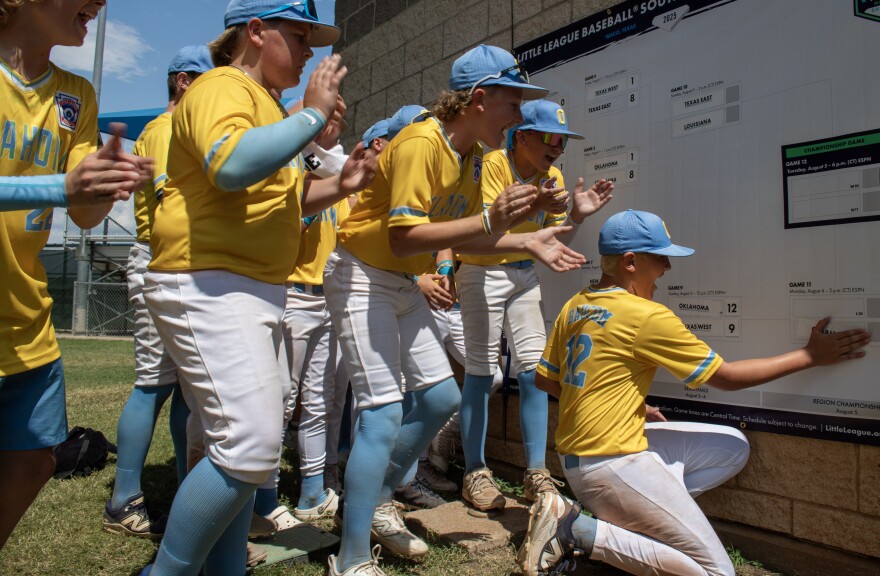 The boys of the Oklahoma 12U team place their sticker on the tournament bracket Sunday after beating Texas West (Midway Little League) to secure a spot in the Southwest Region Tournament Semifinals.