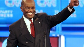 Republican presidential candidate businessman Herman Cain gives the thumbs up during a break in a Republican presidential debate Monday, Sept. 12, 2011, in Tampa, Fla. (AP Photo/Mike Carlson)