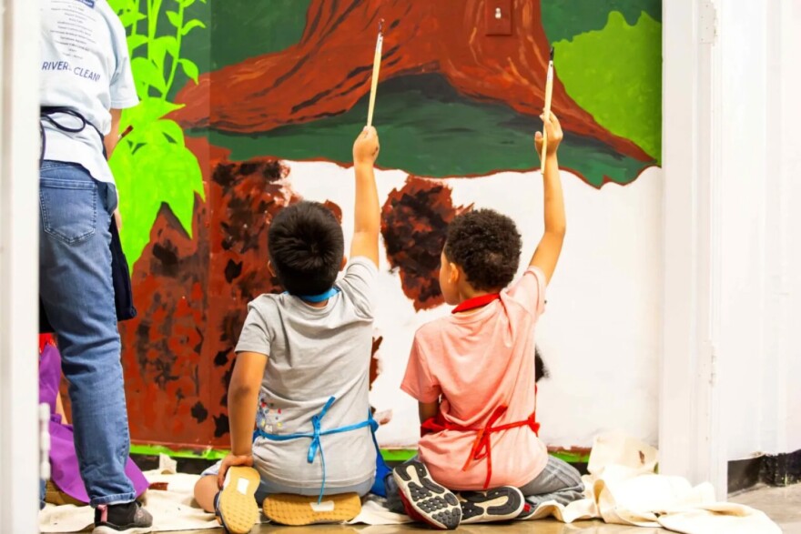 Two kindergarten artists finishing their contributions to the mural project at Chattanooga School for the Arts & Sciences.