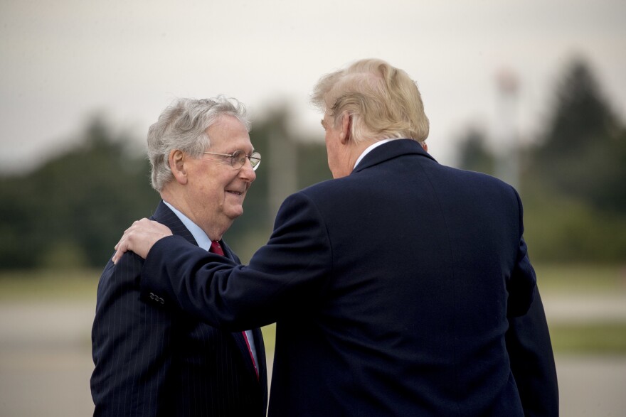 President Trump speaks with Senate Majority Leader Mitch McConnell as they head to an election rally in Kentucky in 2018.