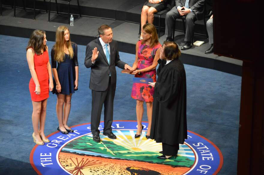 Gov. John Kasich takes the ceremonial oath of office at the Ohio Theatre in 2014 with his wife Karen and his daughters Emma and Reece looking on.