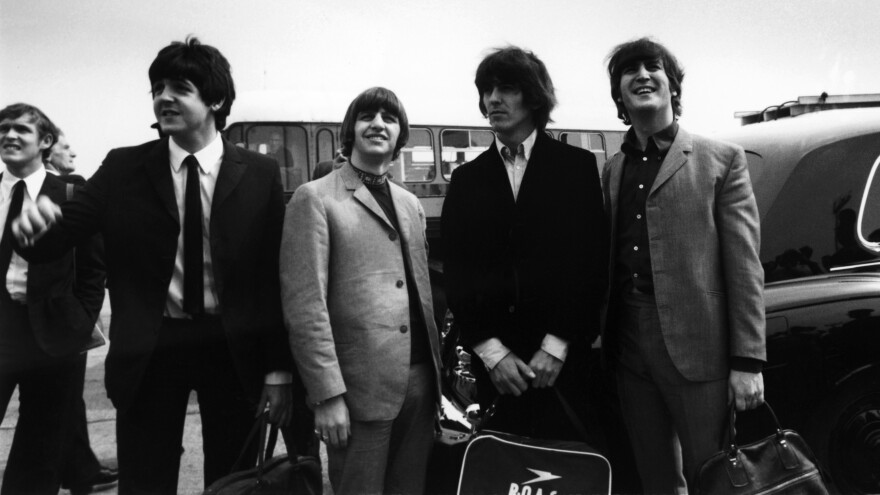 Paul McCartney, Ringo Starr, George Harrison and John Lennon prepare to take off for a U.S. tour on Aug. 13, 1965. Fourteen days later, they'd find themselves in a much-anticipated but very awkward meeting with Elvis Presley.