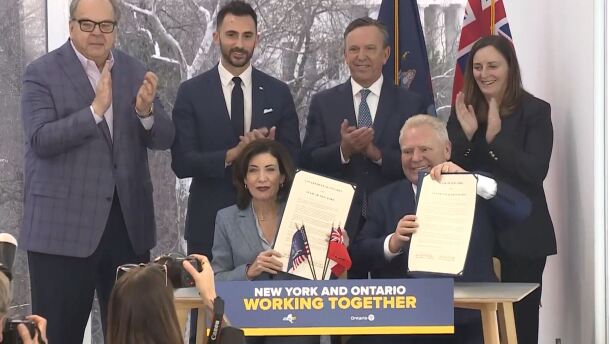 New York Governor Kathy Hochul (left) and Ontario Premier Doug Ford (right) sign an agreement to collaboratively work on nuclear energy projects.