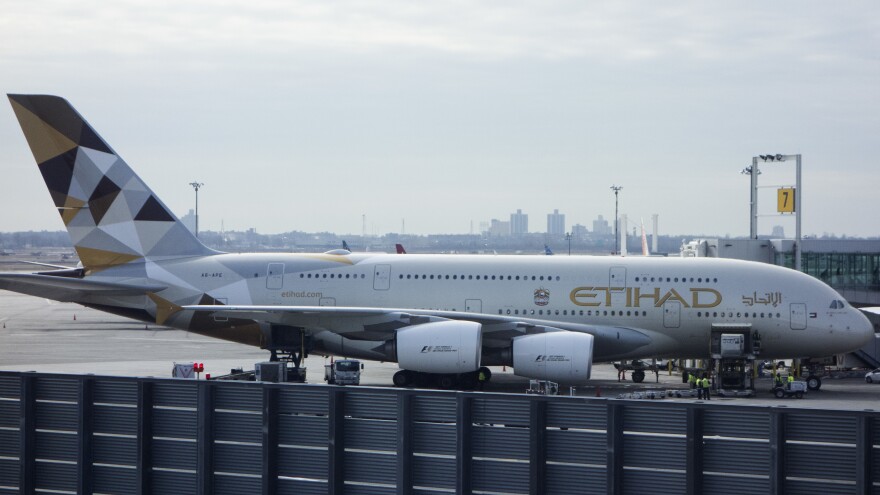 An Etihad Airways jet is parked at JFK International Airport in New York on Tuesday. Passengers traveling to the United States from 10 airports in eight Muslim-majority countries will have to check most electronics. The ban will affect flights on Royal Jordanian, EgyptAir, Turkish Airlines, Saudi Arabian Airlines, Kuwait Airways, Royal Air Maroc, Qatar Airways, Emirates and Etihad Airways.