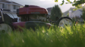 A close up of a lawn mower in a yard
