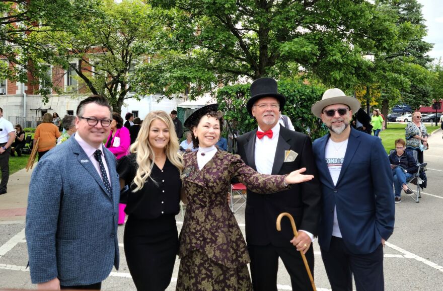 Daniel Thomas of the Illinois Office of Tourism, Erin Anderson, Debra Miller (portraying Lizzie Magie), Allen Nemec (portraying Mr. Monopoly), and Jock Hedblade (left to right) before the ribbon cutting celebration.