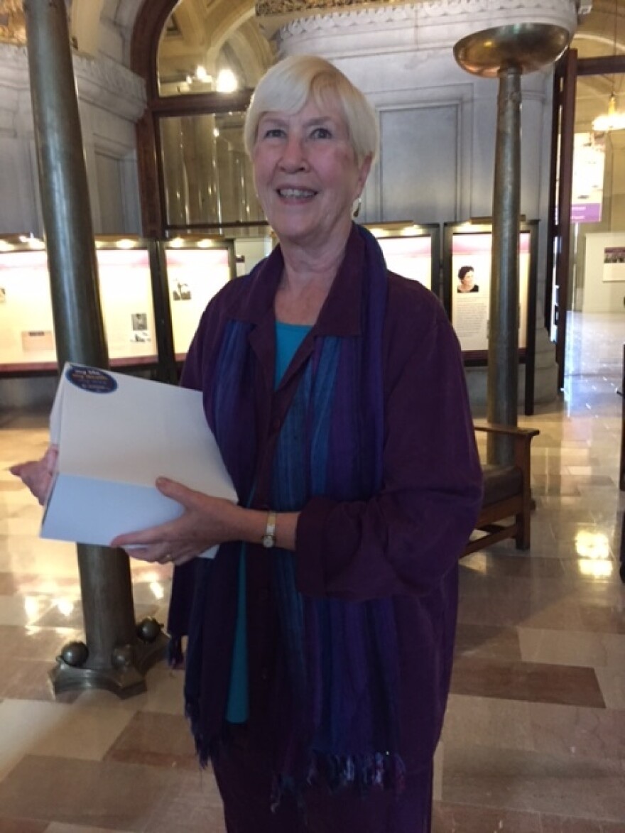 Aid-in-dying supporter Nancy Murphy holds petitions that ask Gov. Andrew Cuomo and the state Legislature to allow the terminally ill to end their lives with medical aid.