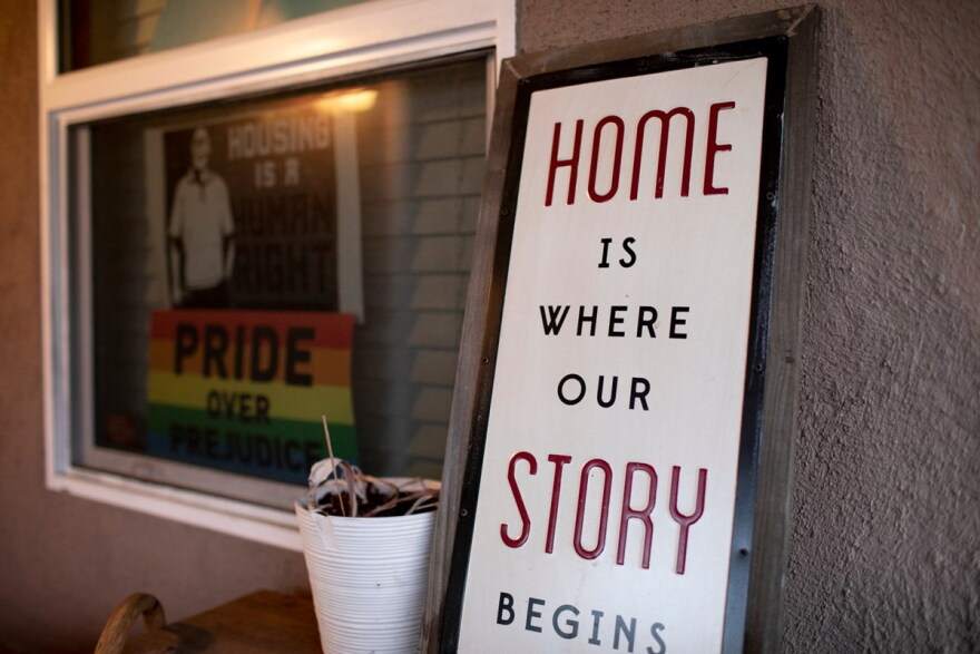 Signs on the front porch of Merika Reagan’s Oakland home show support for housing rights and gay pride.