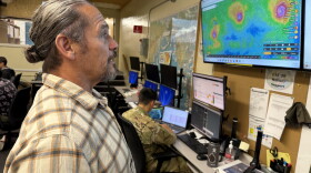 David Lopez, administrator of the Hawaiʻi Emergency Management Agency, looks at screens inside agency headquarters in Honolulu on Thursday, Sept. 3, 2026.