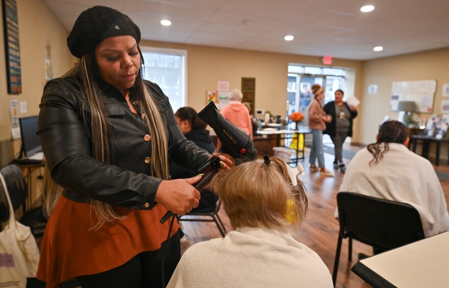 Juana Vasquez of Artistry Studios cuts a client's hair at Keystone Mission in Wilkes-Barre.