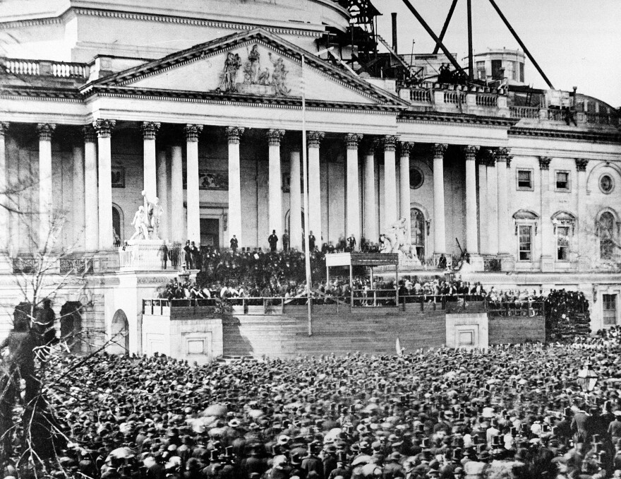 President Abraham Lincoln stands under cover at center of Capitol steps during his inauguration in Washington, D.C., on March 4, 1861.