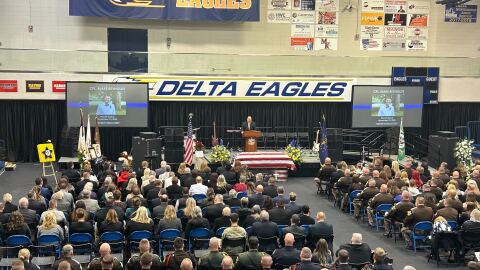Pastor Brian White of Harvest Church starting the funeral service at Delta High School.