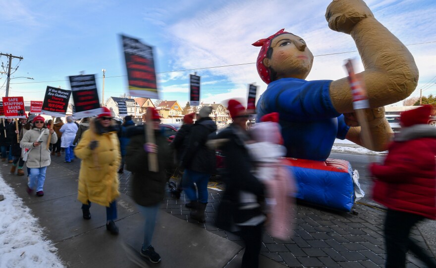 A large inflatable of Rosie the Riveter stood outside the Emergency Room while employees picketed.