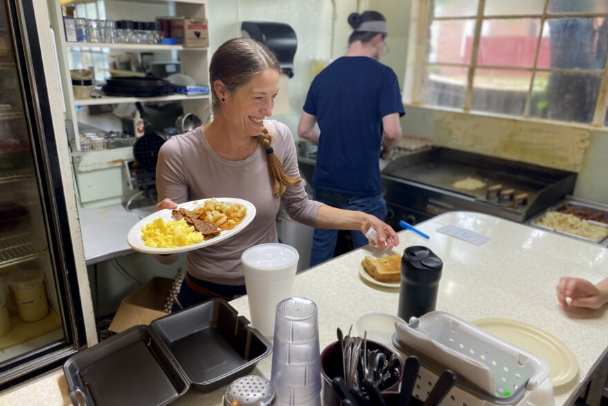 Brenda Kearney, co-owner of the Thomas House restaurant in Dayton, carries a diner's breakfast order.