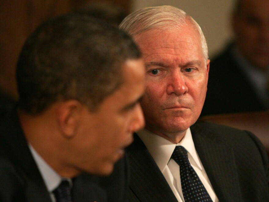 Secretary Gates listens as President Obama speaks at a Cabinet meeting at the White House. Gates began serving as defense secretary under the Bush administration, and was the first to continue under a different party.