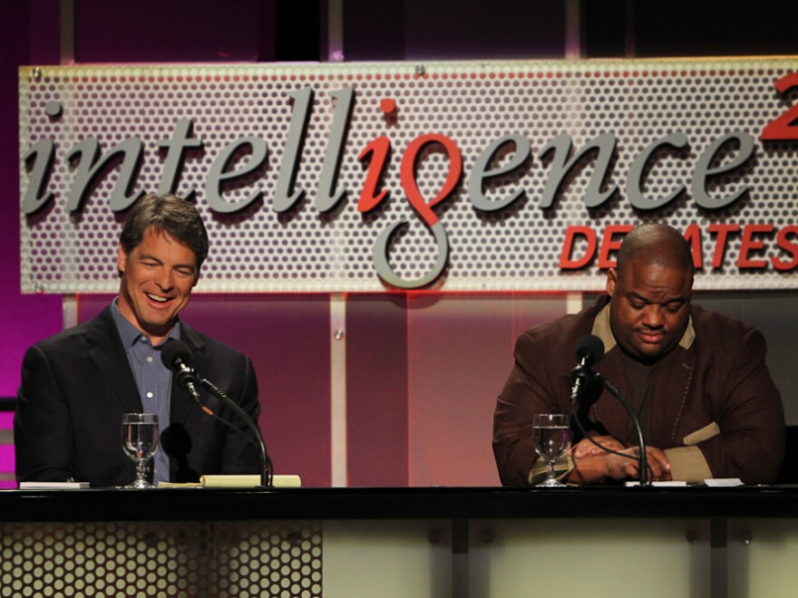 Tim Green (left) and Jason Whitlock argue against banning college football at a May 8 <em>Intelligence Squared</em> debate.