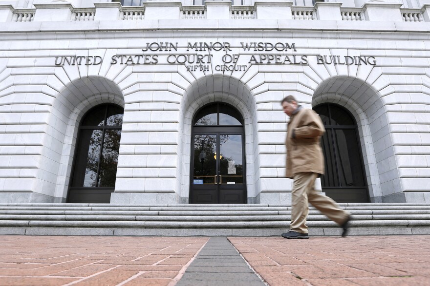 In this Jan. 7, 2015, file photo, a man walks in front of the 5th U.S. Circuit Court of Appeals in New Orleans.