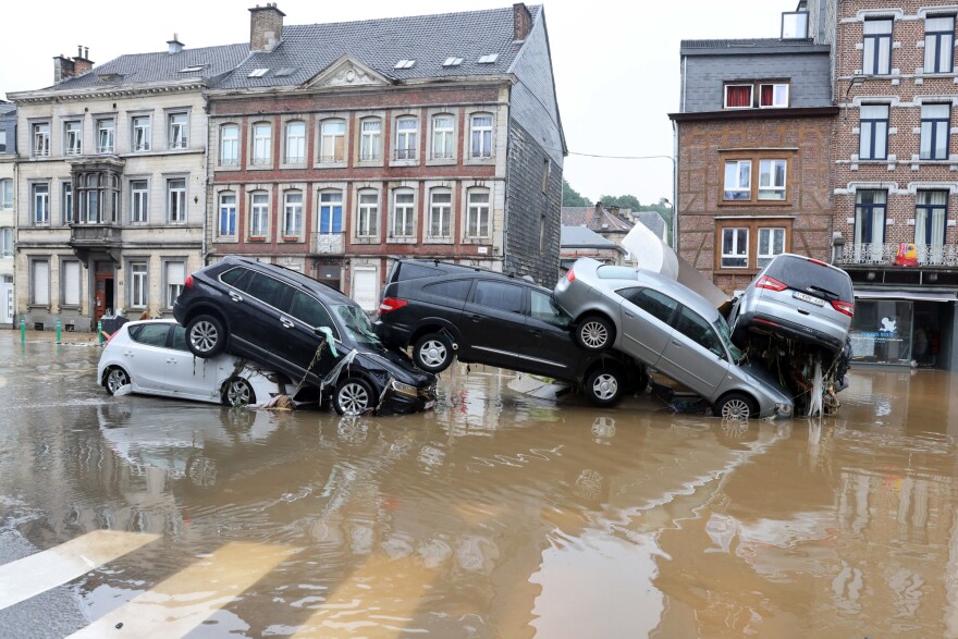 Cars are piled up by the water at a roundabout in the Belgian city of Verviers on Thursday after heavy rains and floods lashed Western Europe.