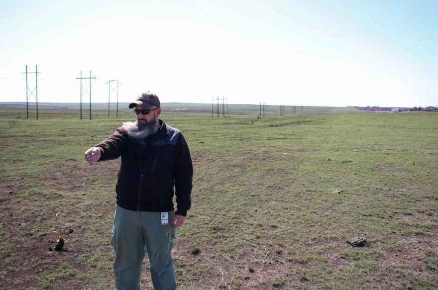 Archie Stone, the wildland coordinator for the Borger Fire Department, points to where the Windy Deuce fire stopped next to a 2023 prescribed burn line outside the city.