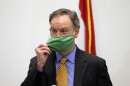 St. Louis County Executive Sam Page removes his mask before talking with reporters on May, 8, 2020.