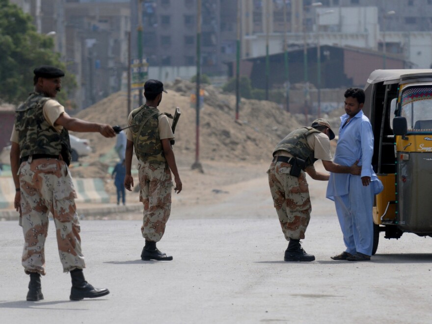 A Pakistani paramilitary soldier frisks a man on a cordoned-off street during house-to-house search operations against criminals, gangs and extortion mafias in a troubled area of Karachi on Aug. 28.