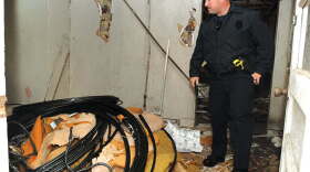 Winchester Police officer David Aldridge looks at some of the wire stolen from the AT&T building at 203 Forrest Ave. over the weekend. The wire was discovered in an abandoned house at the intersection of W