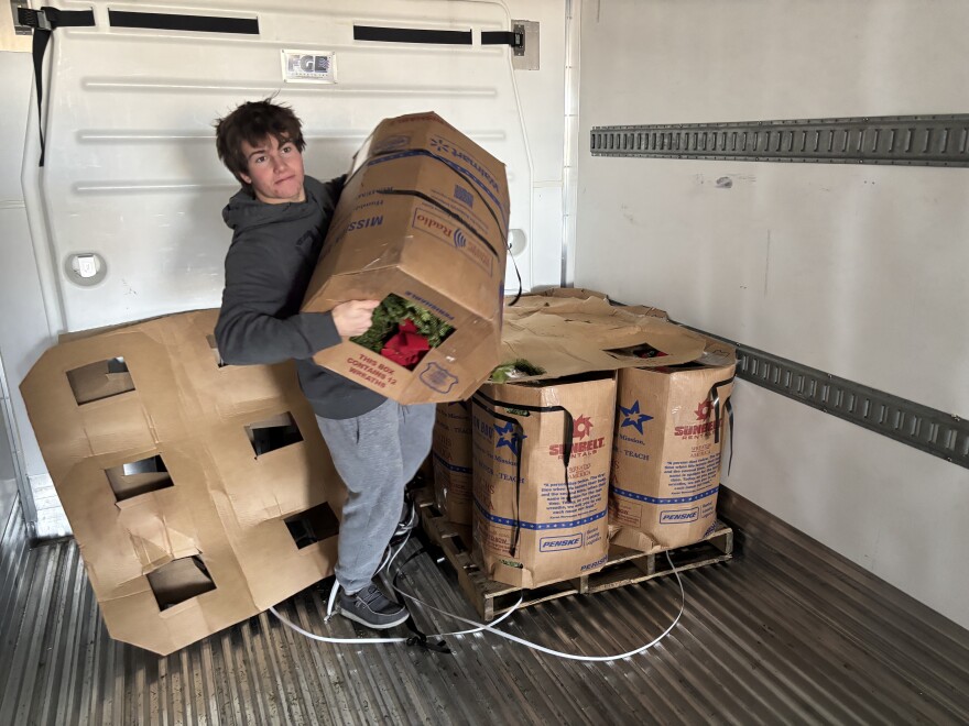 Parker Taix unloads wreaths from a semi-truck in preparation for Wreaths Across America events in the Wasatch Back.