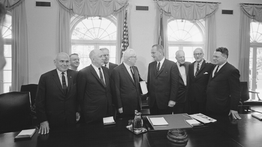 The Warren Commission delivers its report on Kennedy's assassination to President Lyndon B. Johnson in the Cabinet Room of the White House on Sept. 24, 1964. From left: lawyer John McCloy, General Counsel J. Lee Rankin, Sen. Richard Russell, Rep. Gerald Ford, Chief Justice Earl Warren, President Johnson, former CIA Director Allen Dulles, Sen. John Sherman Cooper, and Rep. Hale Boggs.