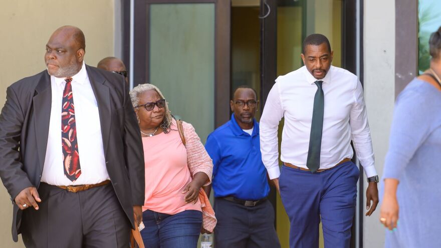 Pictured: Calvert White leaves the District Court House alongside family and his attorney Clive Rivers.