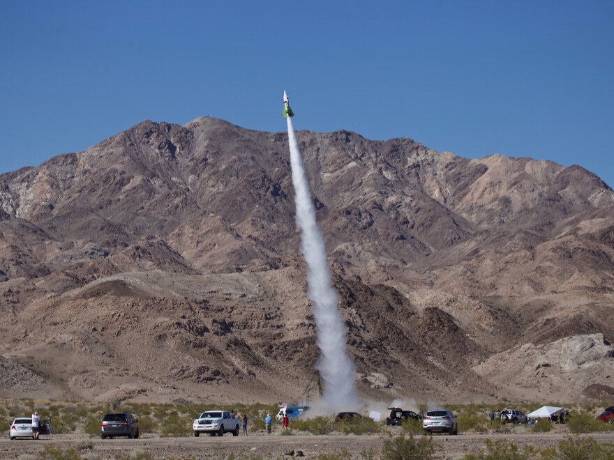 "Mad" Mike Hughes' homemade rocket takes to the skies above Amboy, Calif., on Saturday. The self-taught rocket scientist who believes the Earth is flat propelled himself about 1,875 feet into the air before a hard landing in the Mojave Desert left him injured.