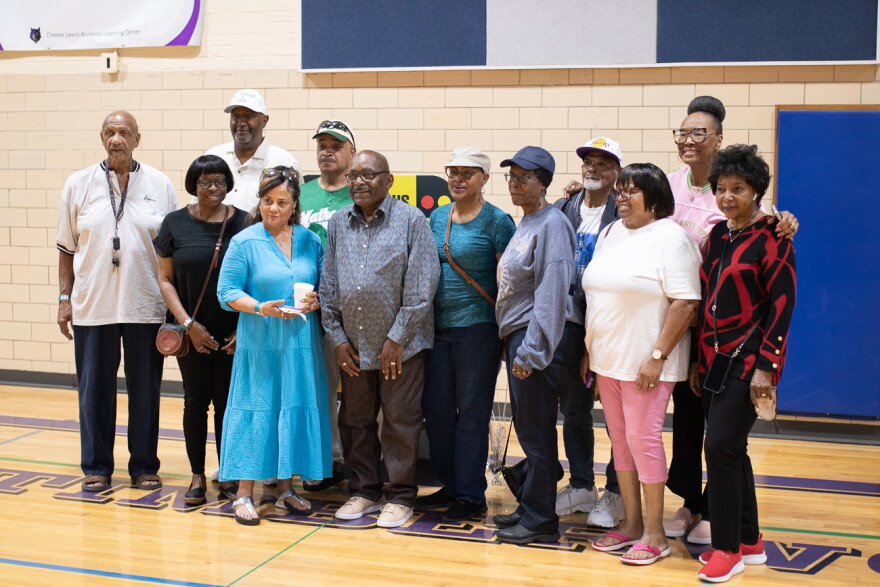 Graduates from Mathewson Junior High pose for a group photo on March 26. The building, most recently home to Chester I. Lewis Alternative High School, is set to be demolished this summer.