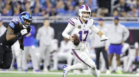 Buffalo Bills quarterback Josh Allen (17) runs against Detroit Lions defensive end Za'Darius Smith during the first half of an NFL football game, Sunday, Dec. 15, 2024, in Detroit. (AP Photo/Rey Del Rio)